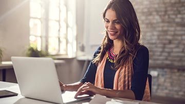 Woman working at a startup records a screen sharing meeting on her laptop